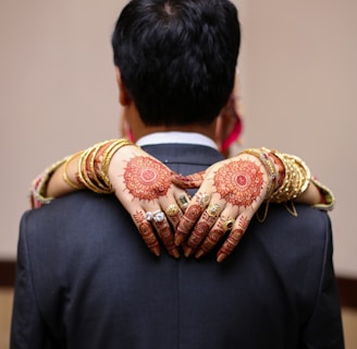 man in black suit jacket holding brown and white ribbon