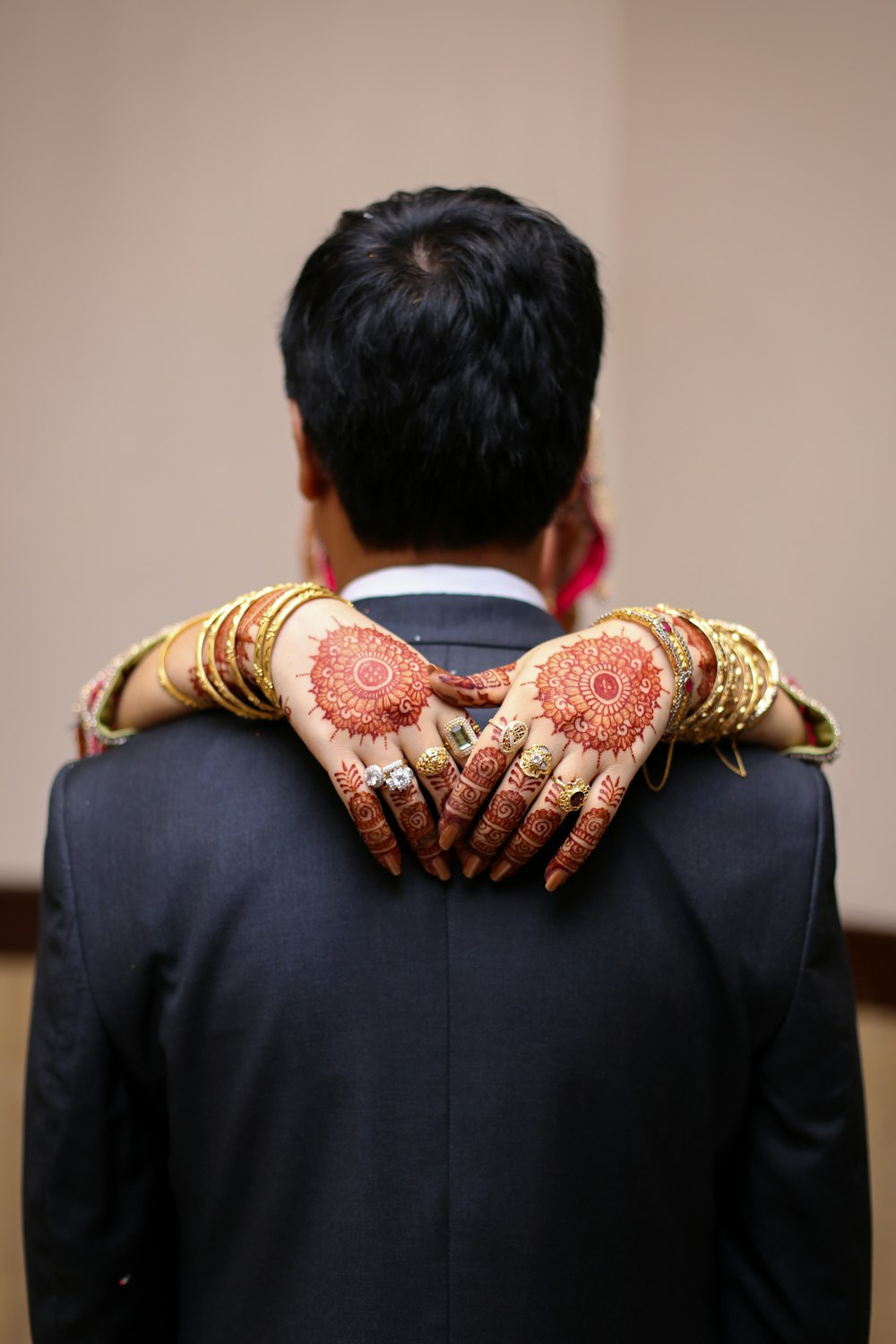 man in black suit jacket holding brown and white ribbon