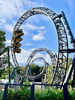 green and brown roller coaster under blue sky during daytime