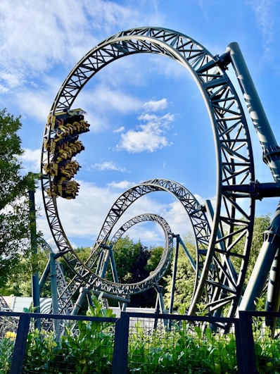 green and brown roller coaster under blue sky during daytime