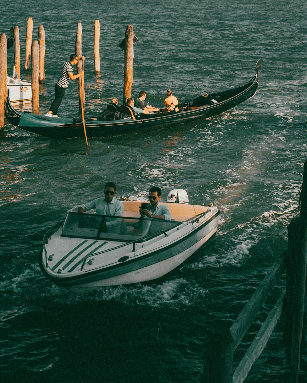 man in black shirt riding on white and black boat during daytime