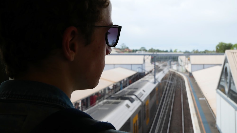 man in black jacket wearing black sunglasses