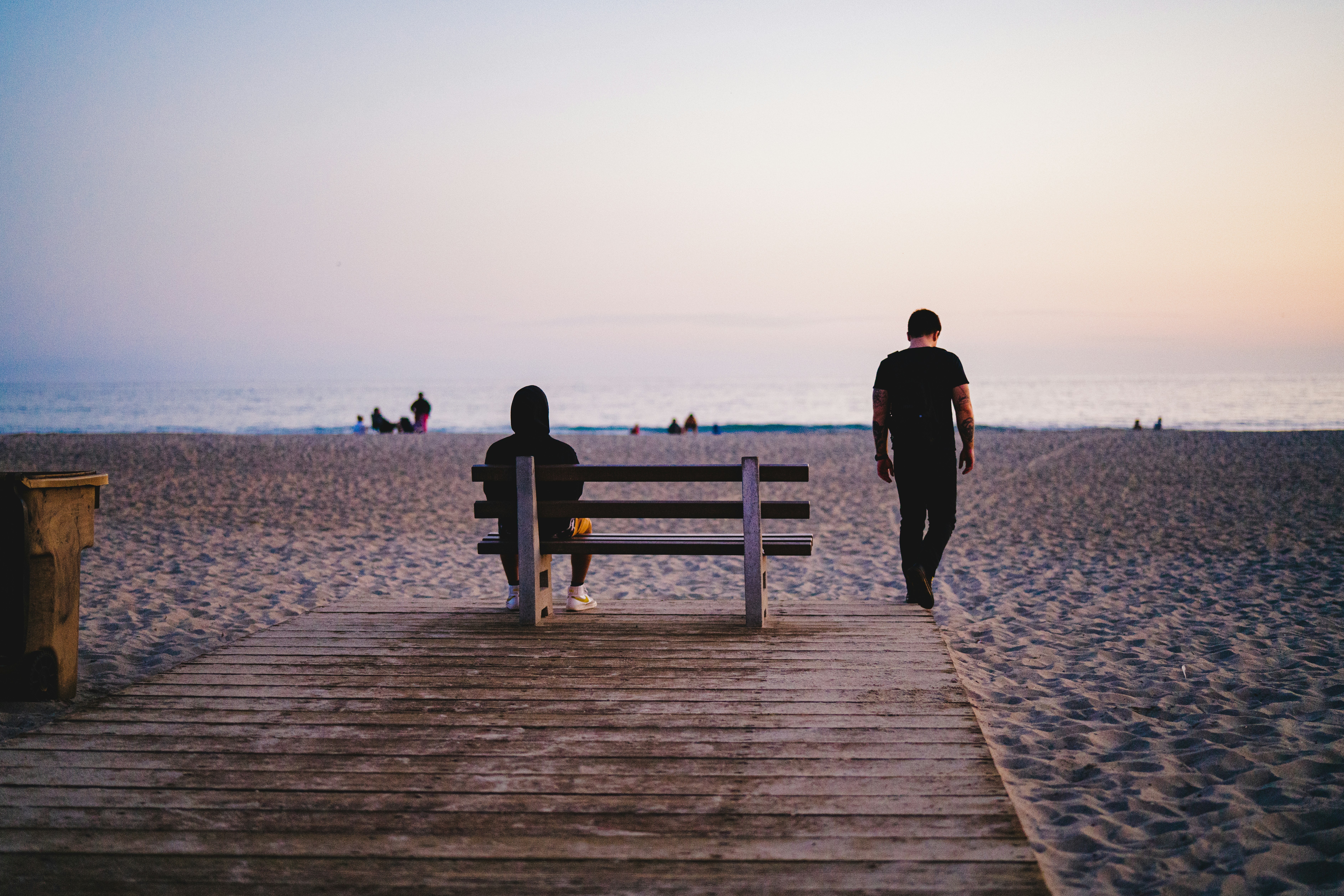 man in black jacket standing on wooden dock during daytime