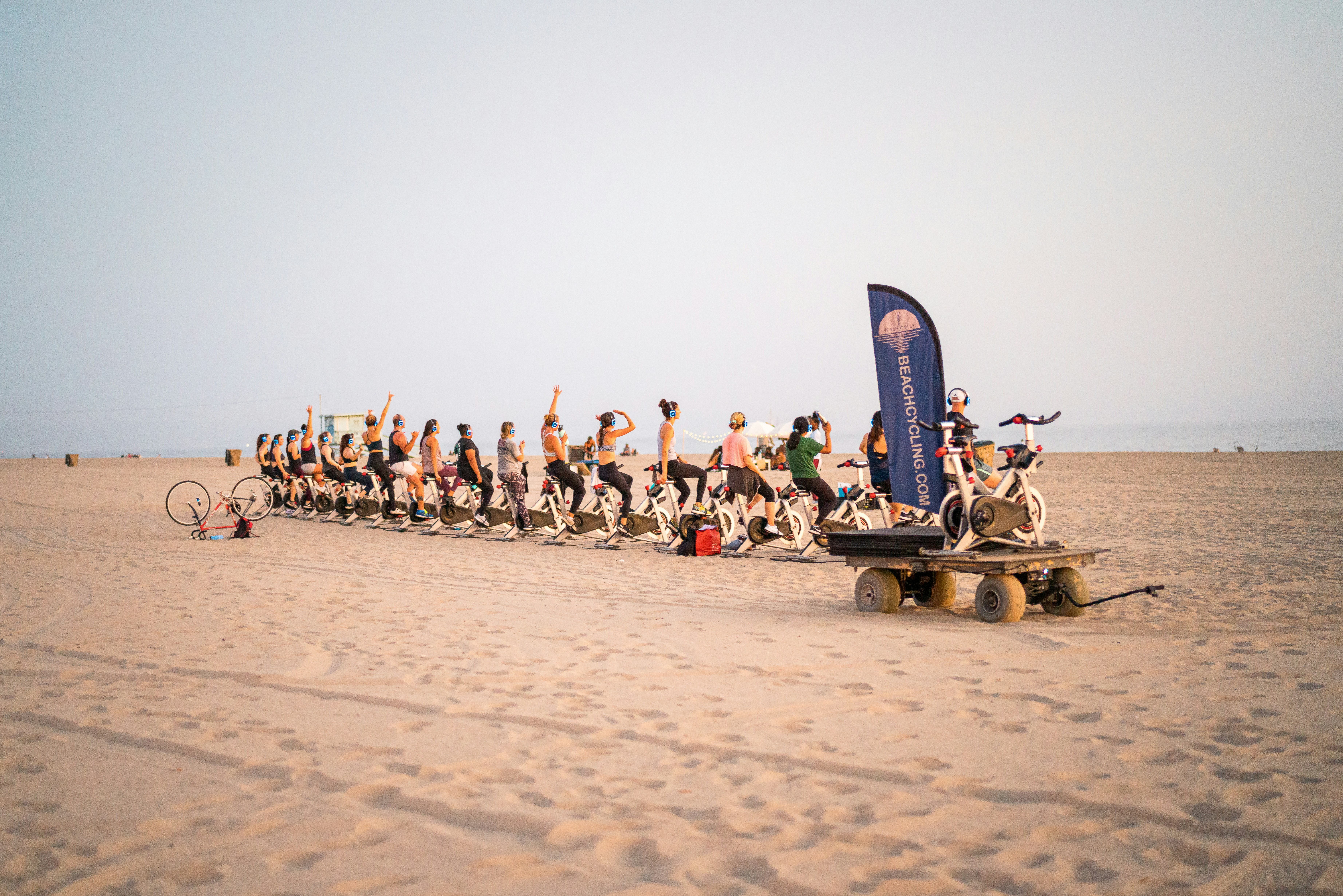 people sitting on brown wooden trailer on brown sand during daytime