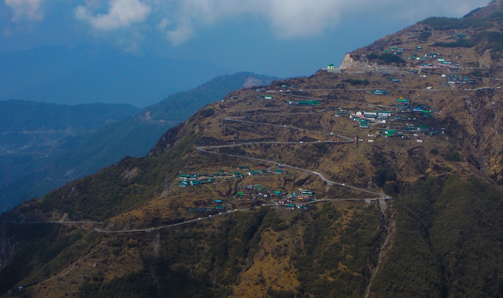 houses on mountain under blue sky during daytime