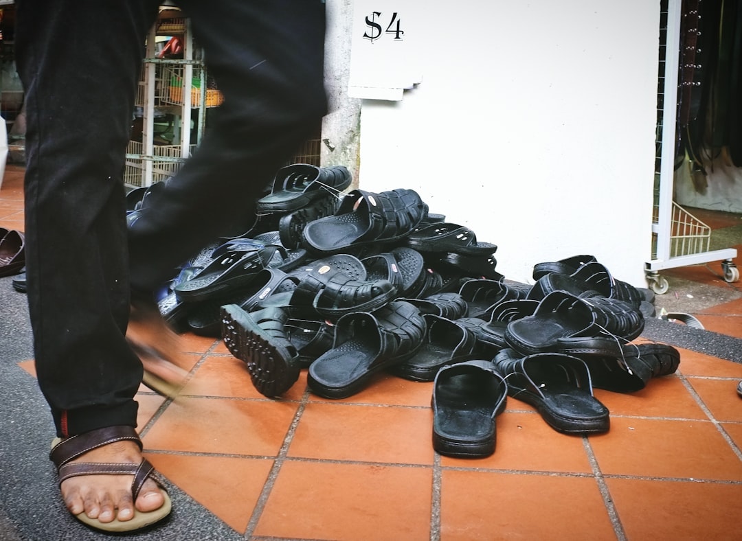 black leather shoes on brown floor tiles