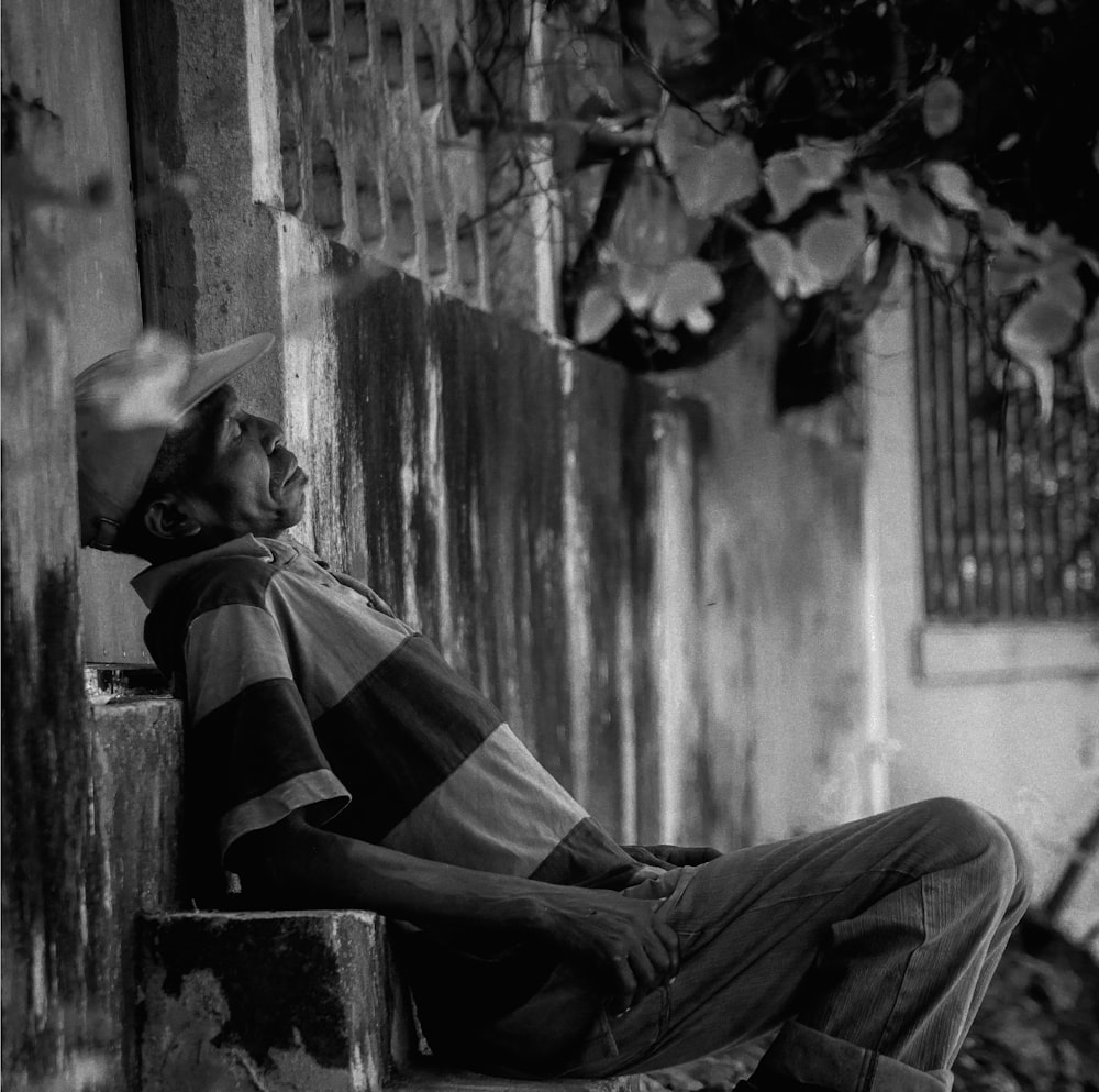 man in black and white plaid shirt sitting on chair