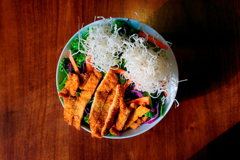 fried food on green and white ceramic bowl