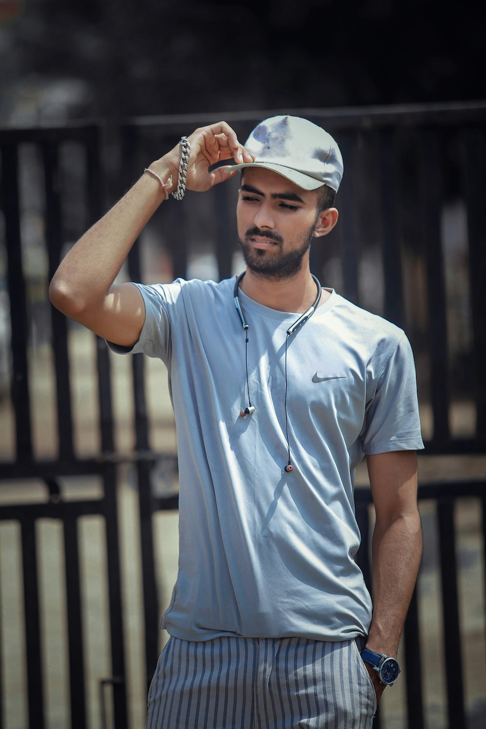 man in blue nike crew neck t-shirt and white cap