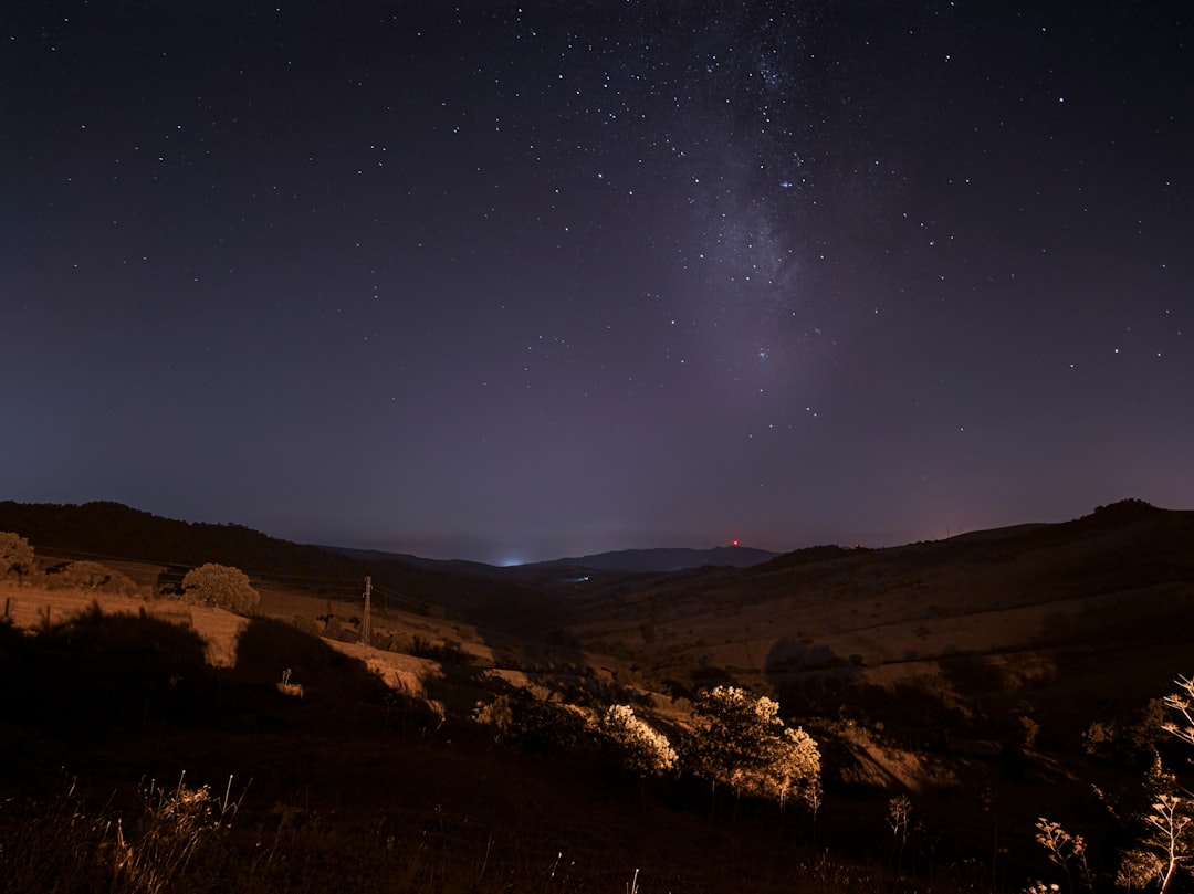 brown mountain under blue sky during night time