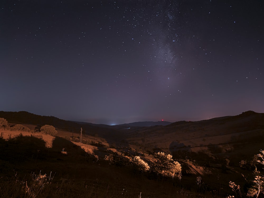 brown mountain under blue sky during night time