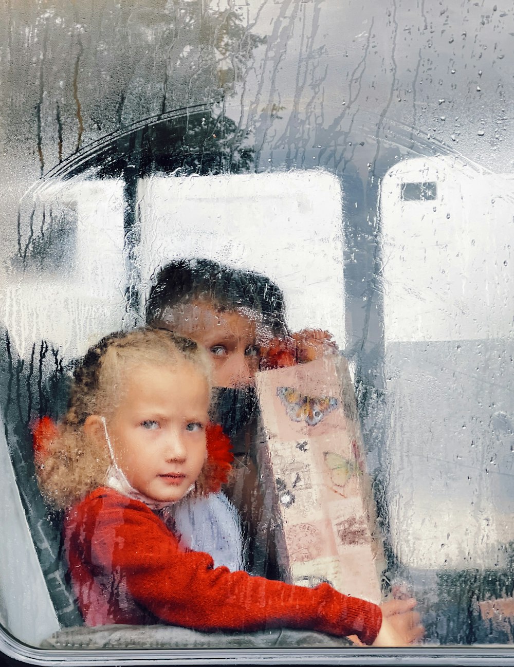 girl in red jacket beside girl in red jacket