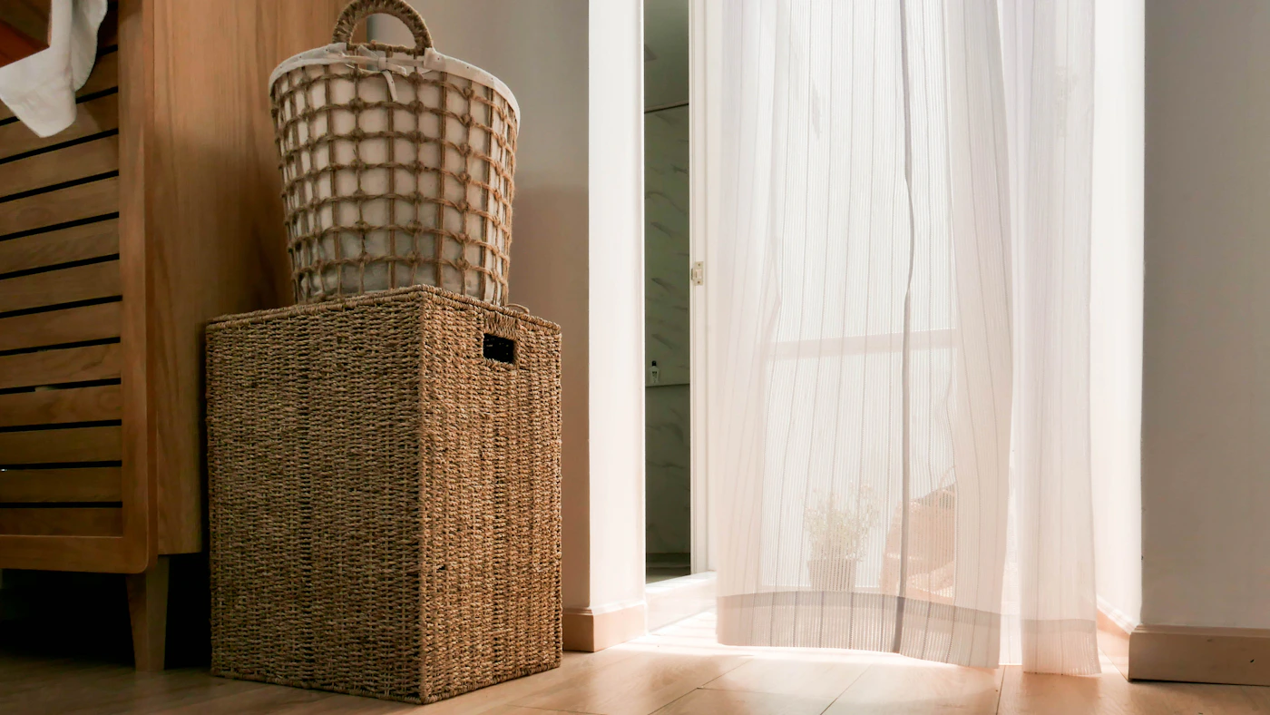 Woven laundry storage baskets in a warm neutral interior
