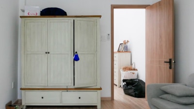 white wooden cabinet near white wall