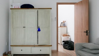 white wooden cabinet near white wall