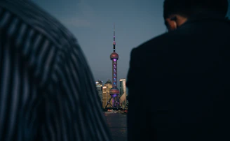 man in black jacket standing near woman in black jacket