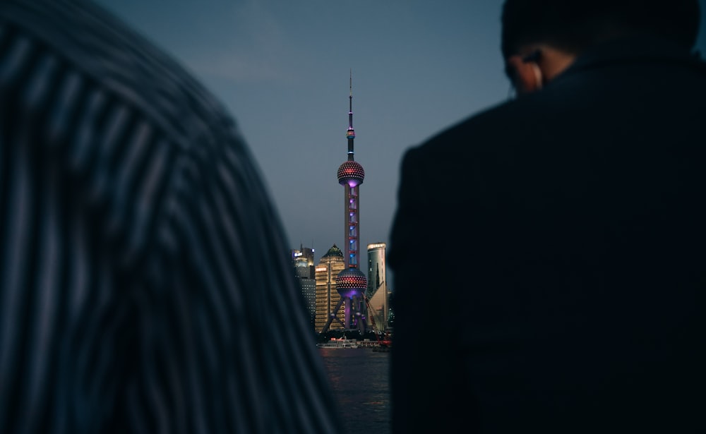 man in black jacket standing near woman in black jacket