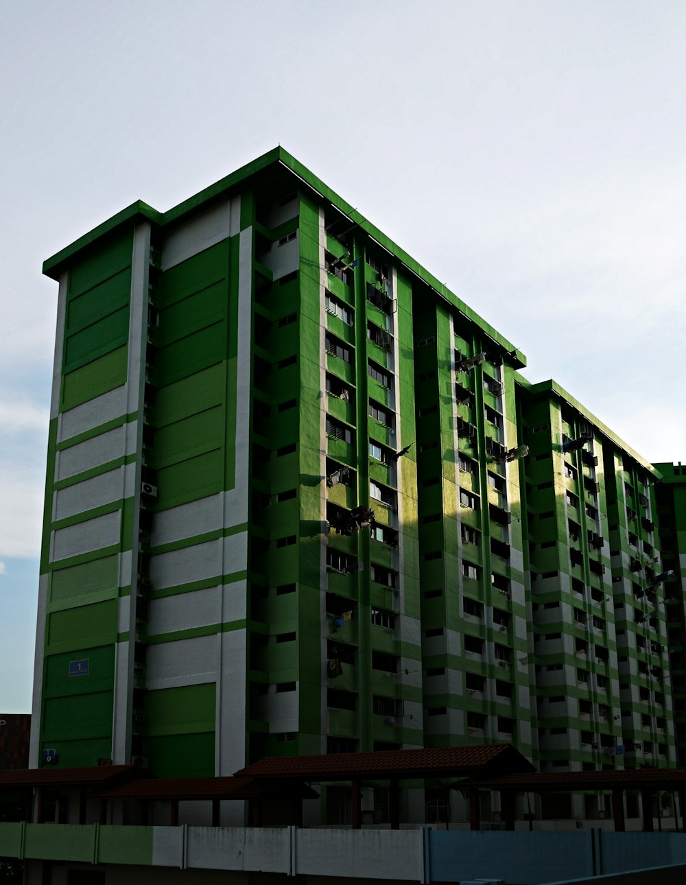 green and brown concrete building under blue sky during daytime