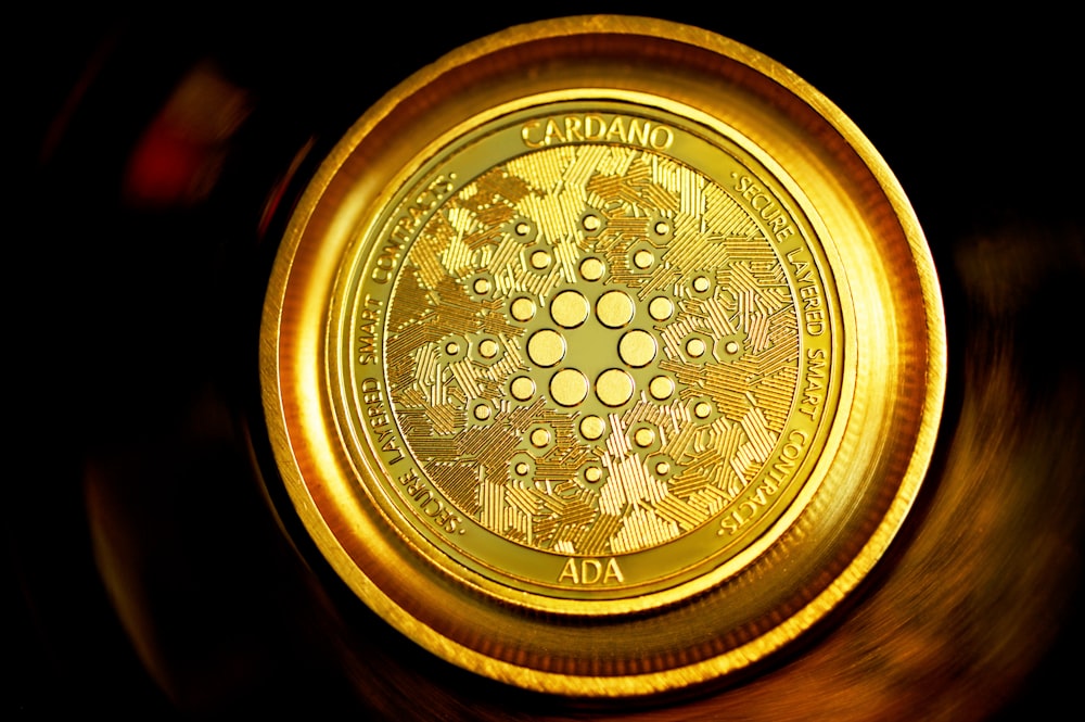 gold round coin on black surface