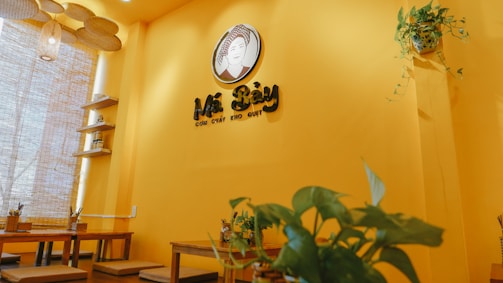 Cozy corner of Tropiceylon Bistro with warm brown and yellow tones, inviting guests to connect.