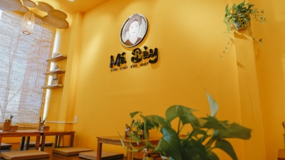 Cozy interior of Quan Ngon Vietnamese Bistro featuring warm wood tones and subtle bamboo green accents.