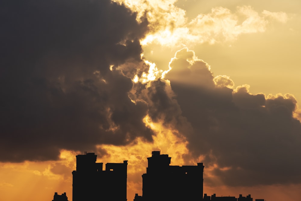 silhouette of building under cloudy sky during sunset