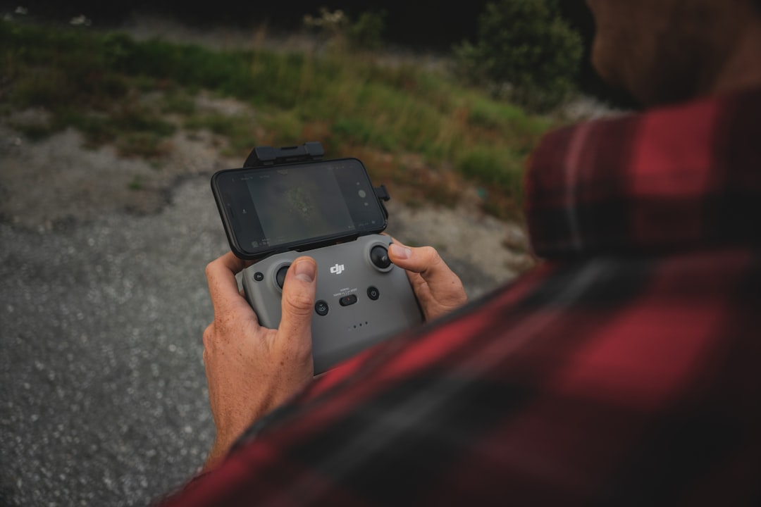 person holding black digital camera