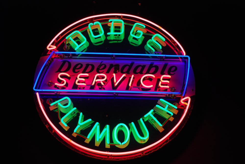 a neon sign for a business called plymouth