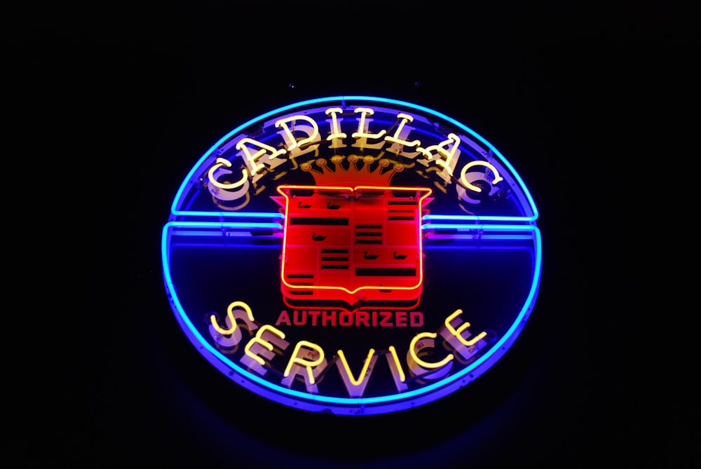 a neon sign for a service station in the dark