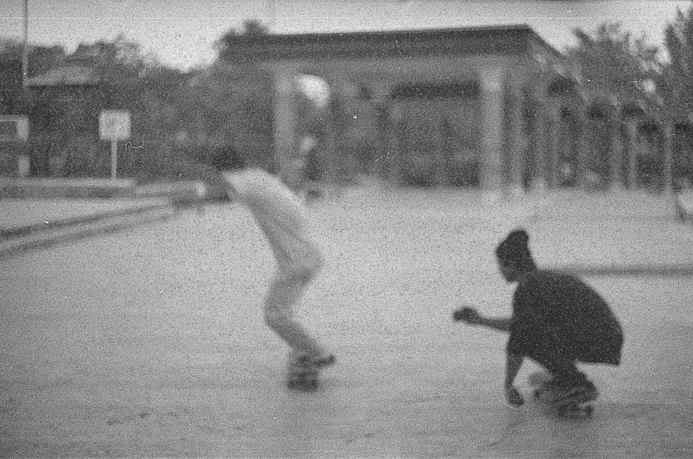 man in black shirt and pants playing basketball in grayscale photography