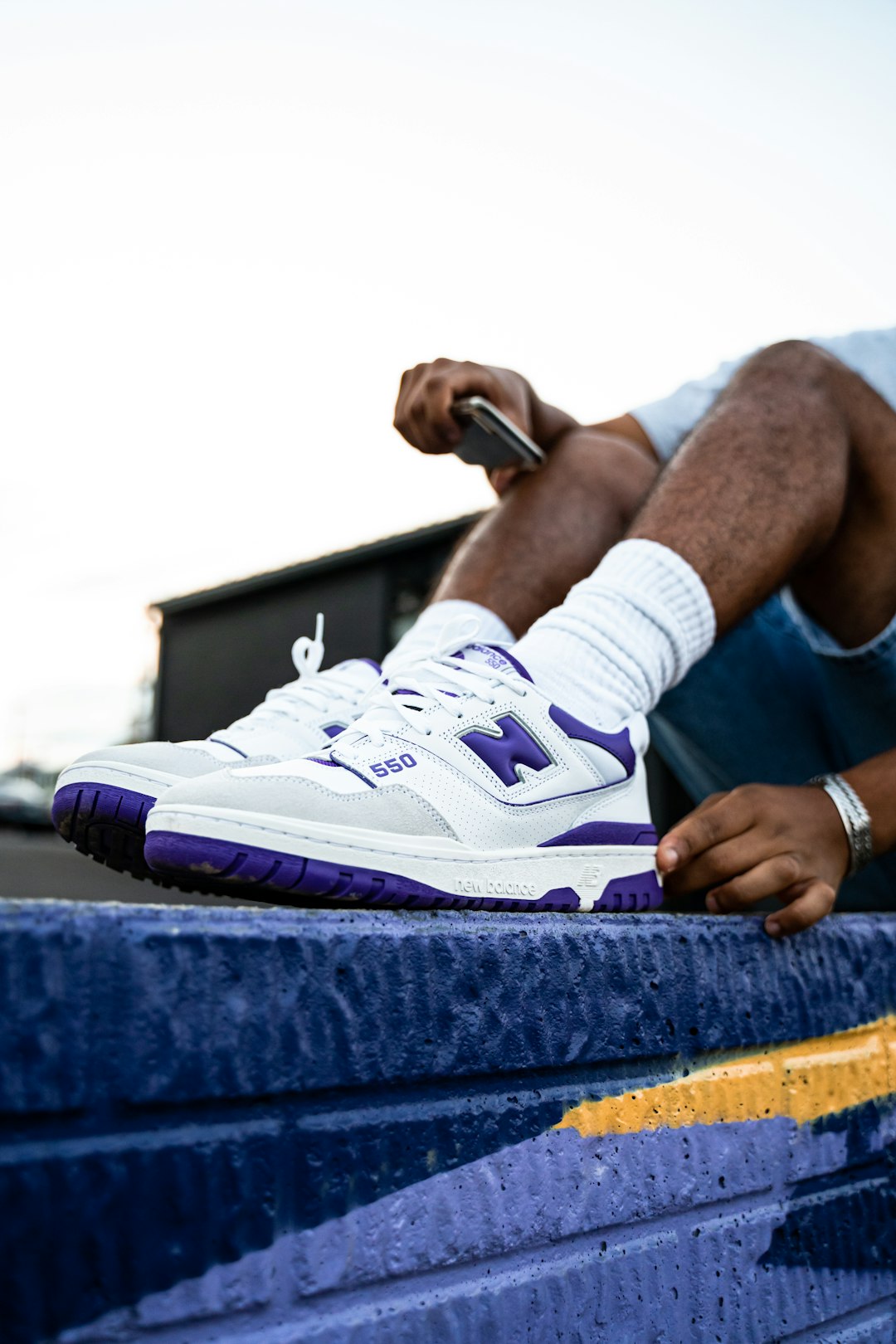 person in white and purple nike sneakers