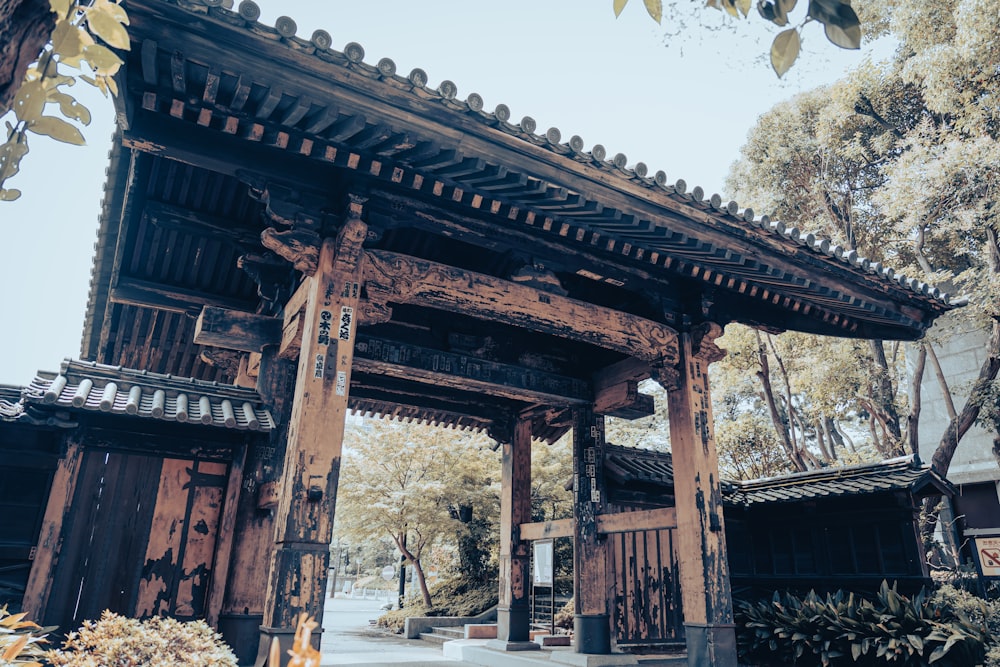 brown wooden building near green trees during daytime