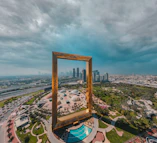 The Dubai Frame standing in a park with the city skyline in Dubai