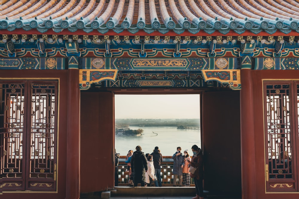 people standing on red and gold temple during daytime