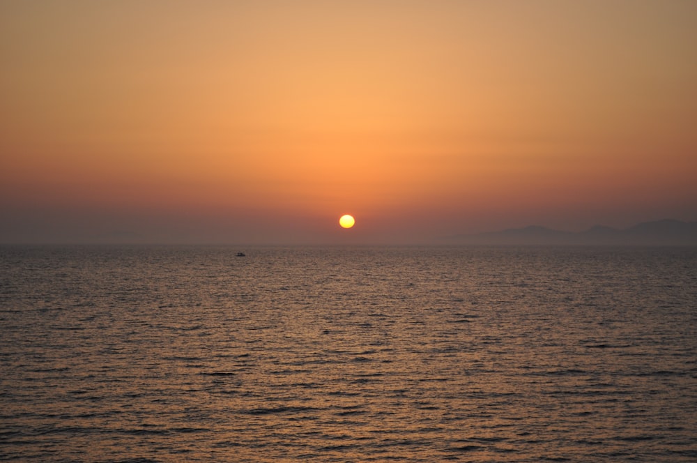 body of water during sunset