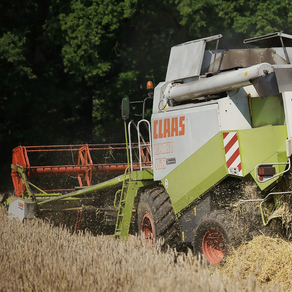 red and green heavy equipment on brown grass field during daytime