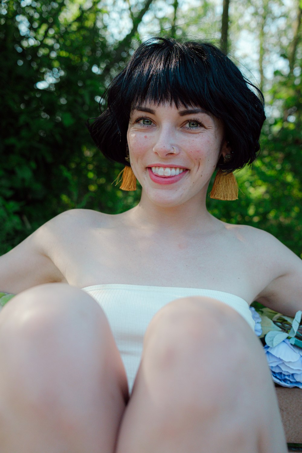 woman in white tube dress smiling