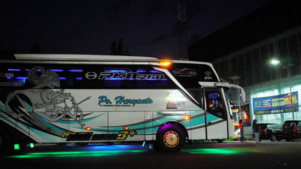 white and red bus on road during night time