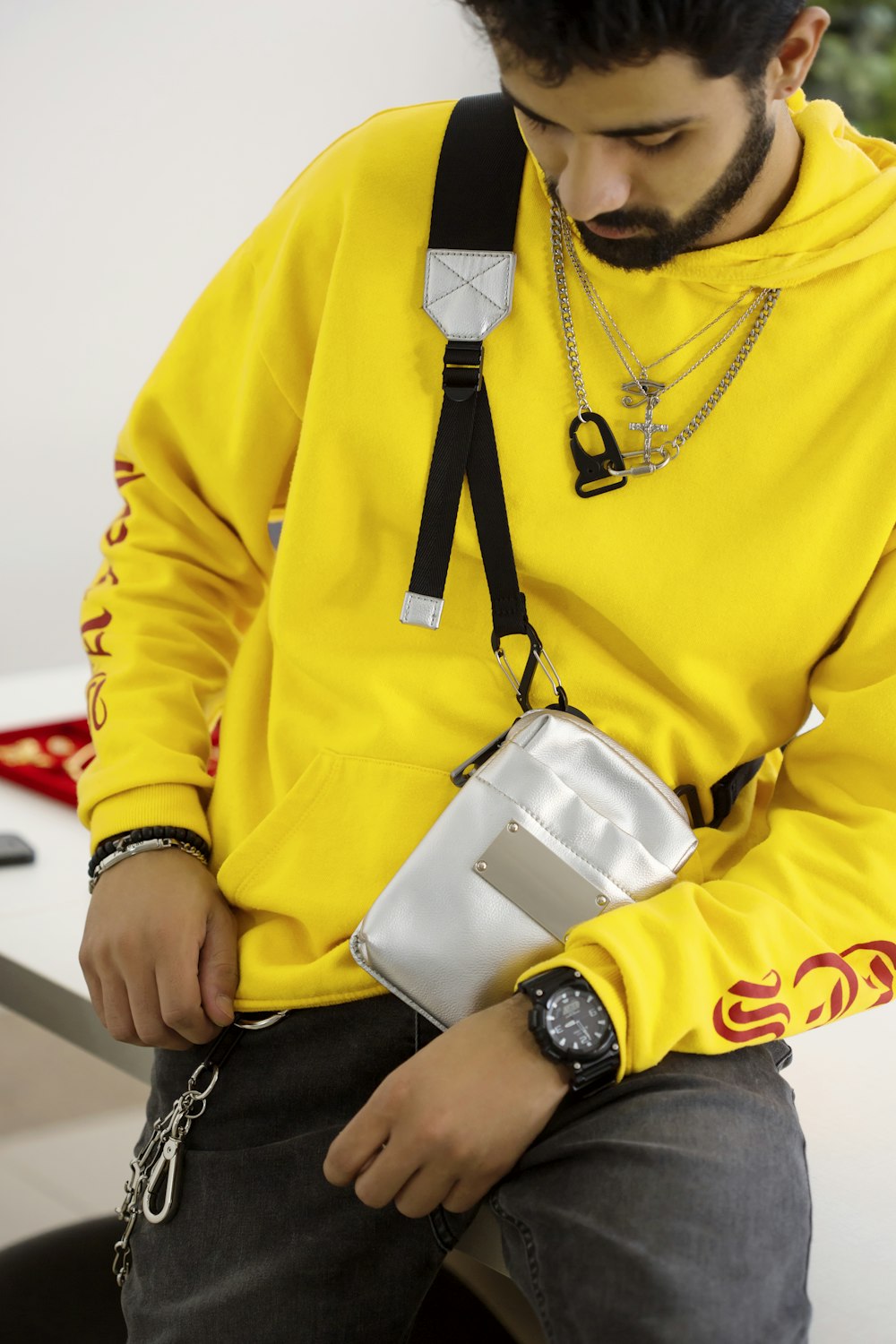 man in yellow jacket wearing black watch