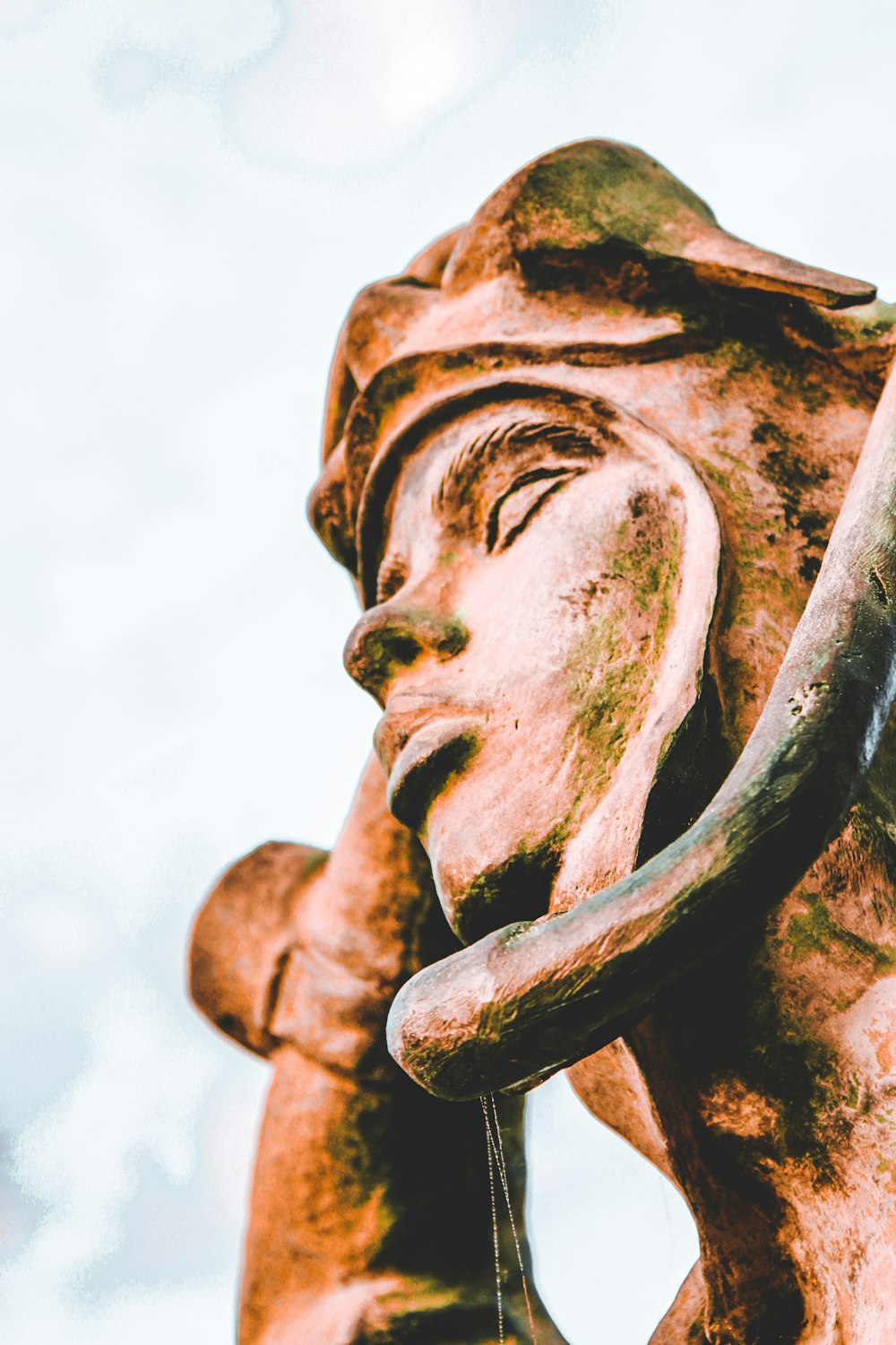 brown concrete statue of man