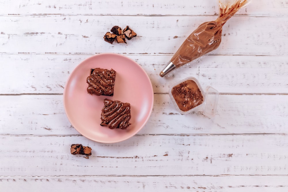 chocolate cookies on pink ceramic plate