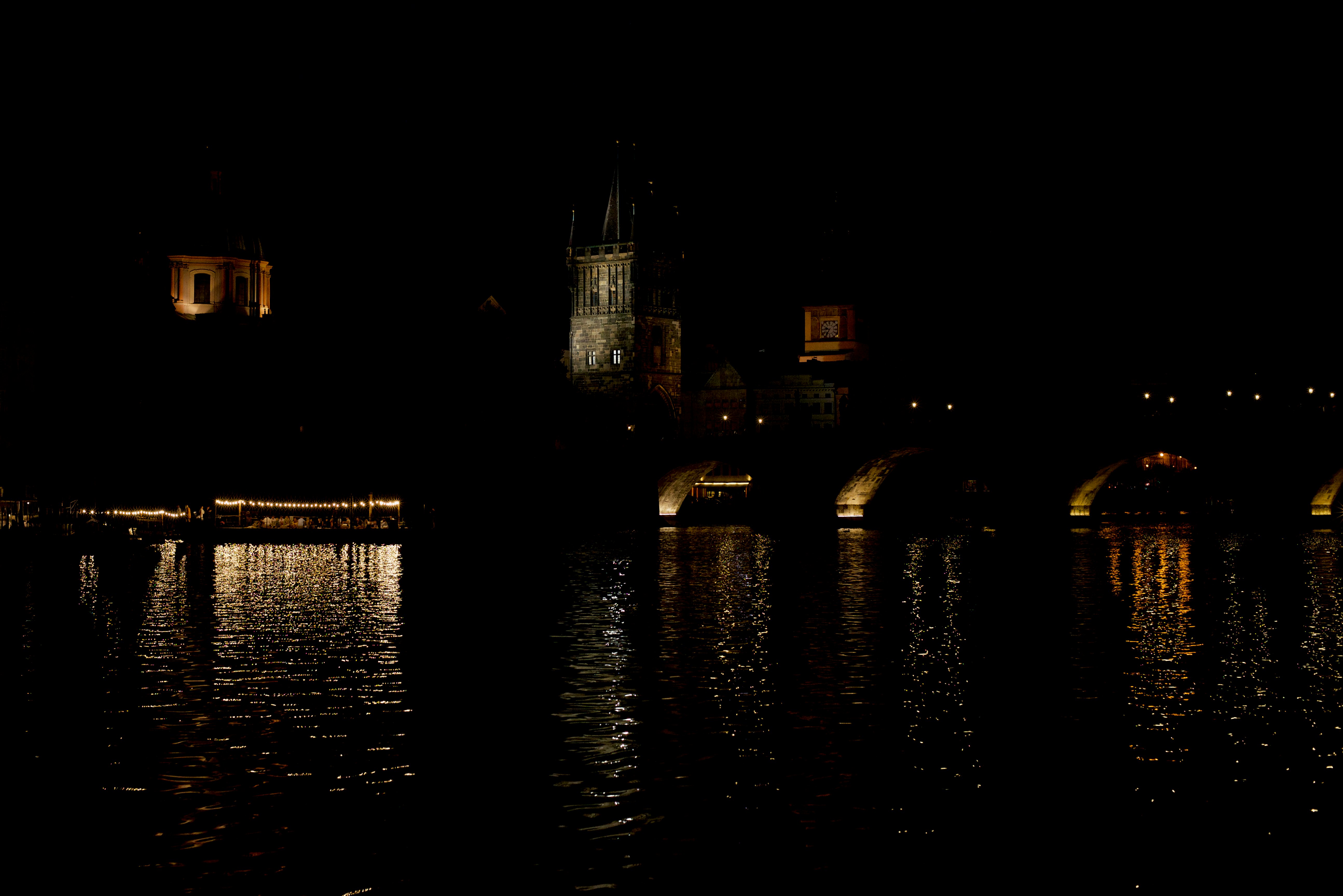 body of water near city buildings during night time