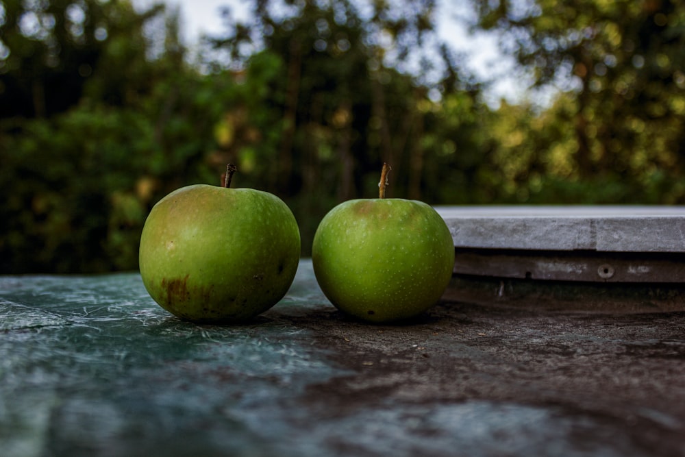 green apple on brown wooden table