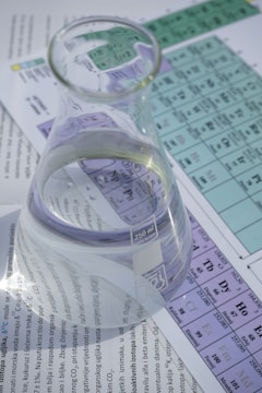 clear glass pitcher on white paper
