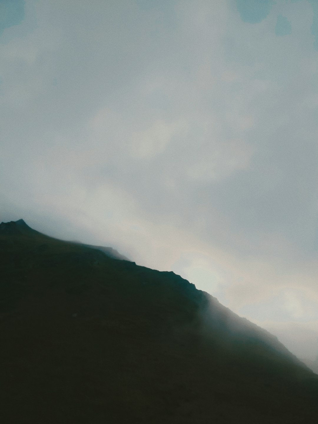 mountain covered with clouds during daytime