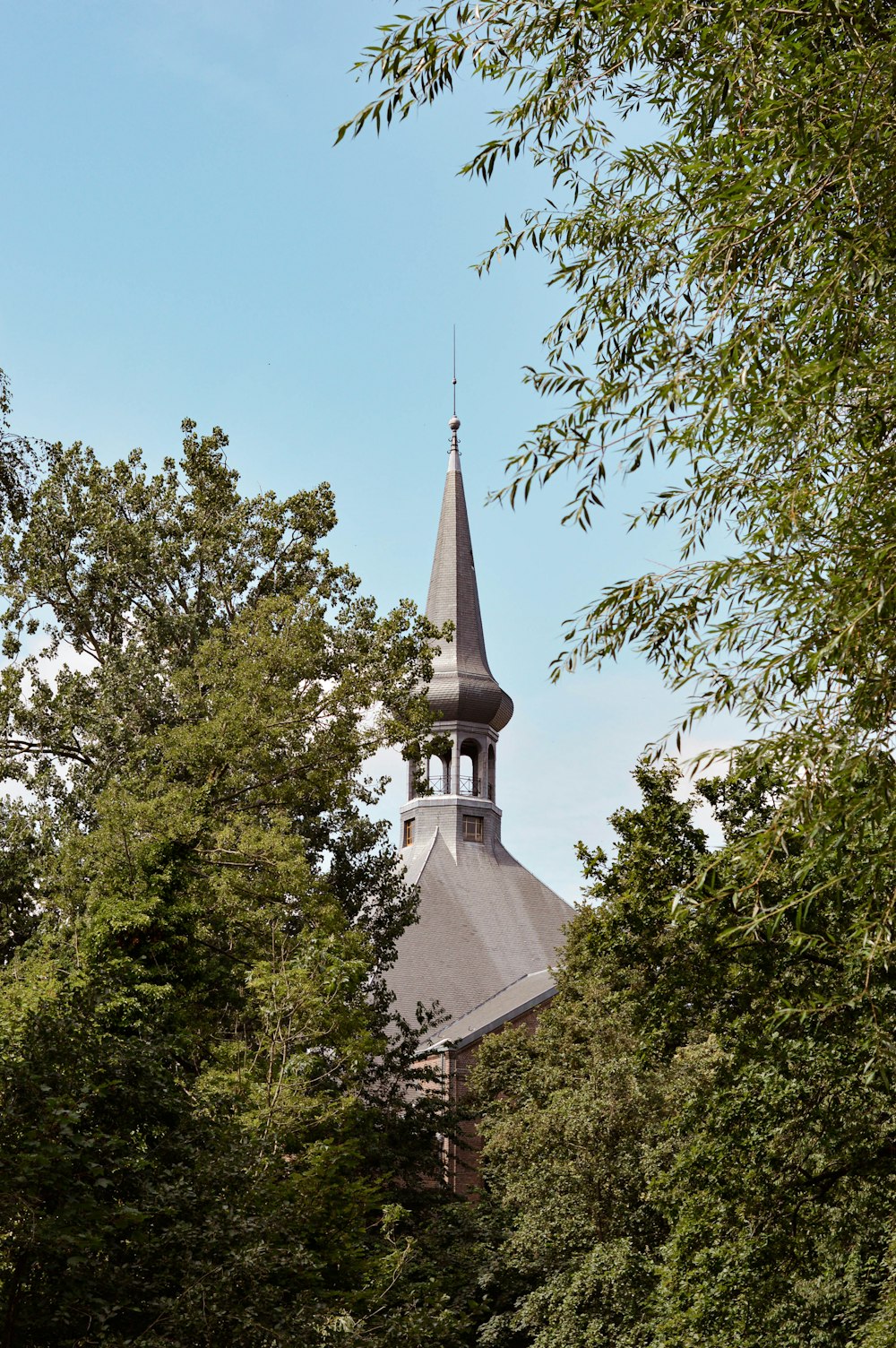 white and gray concrete building near green trees during daytime