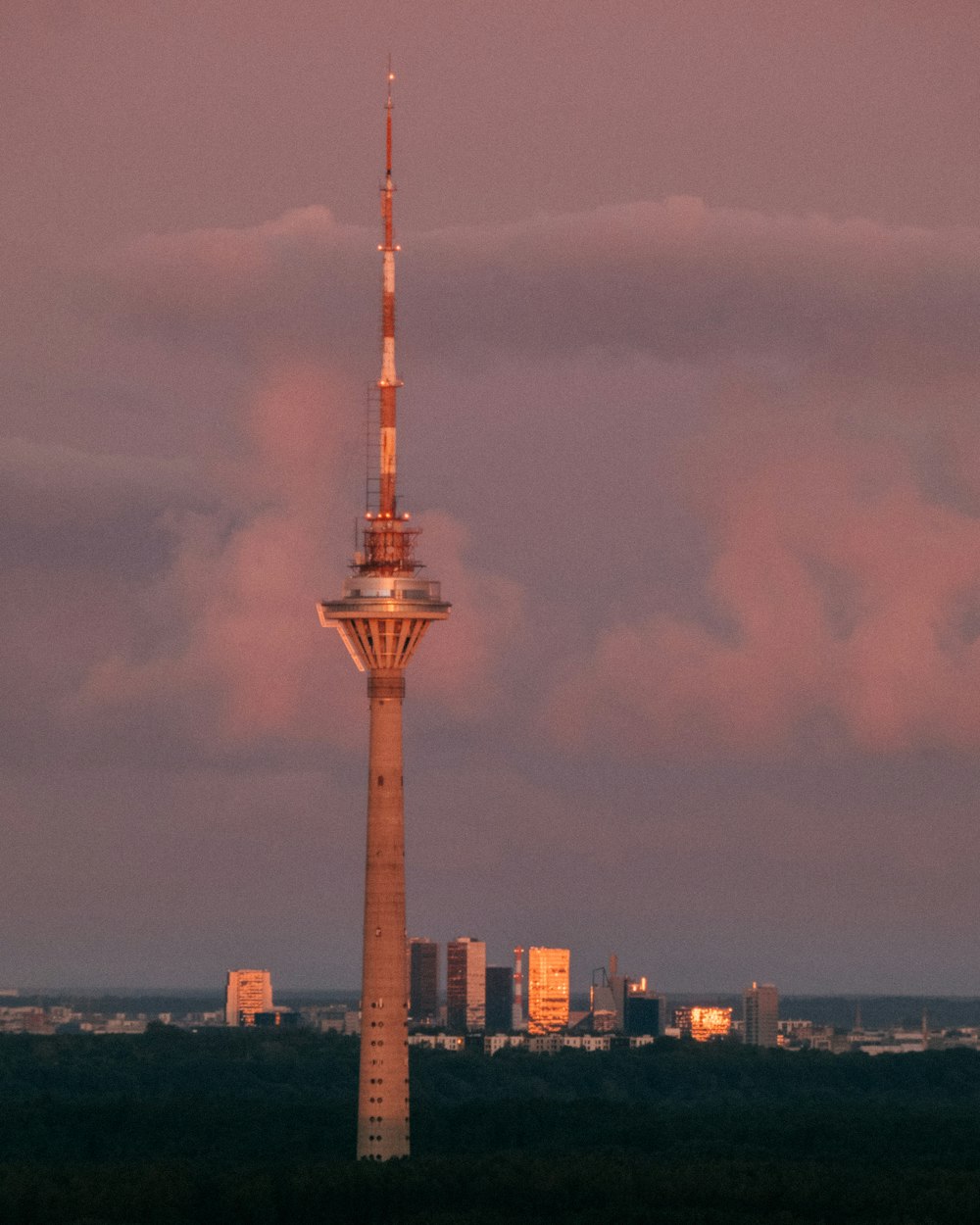 brown and white tower under cloudy sky