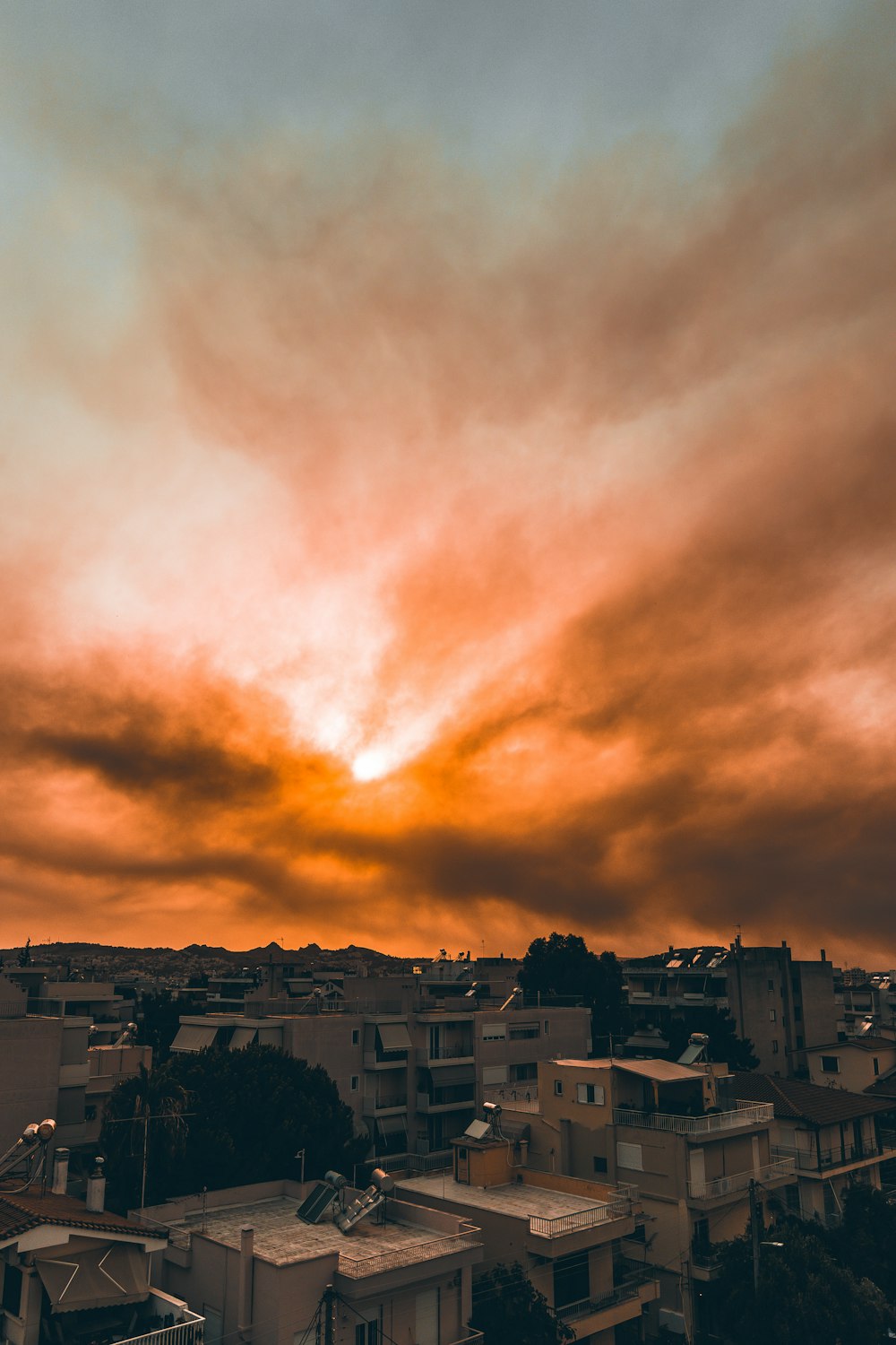 white and brown concrete buildings under white clouds during daytime