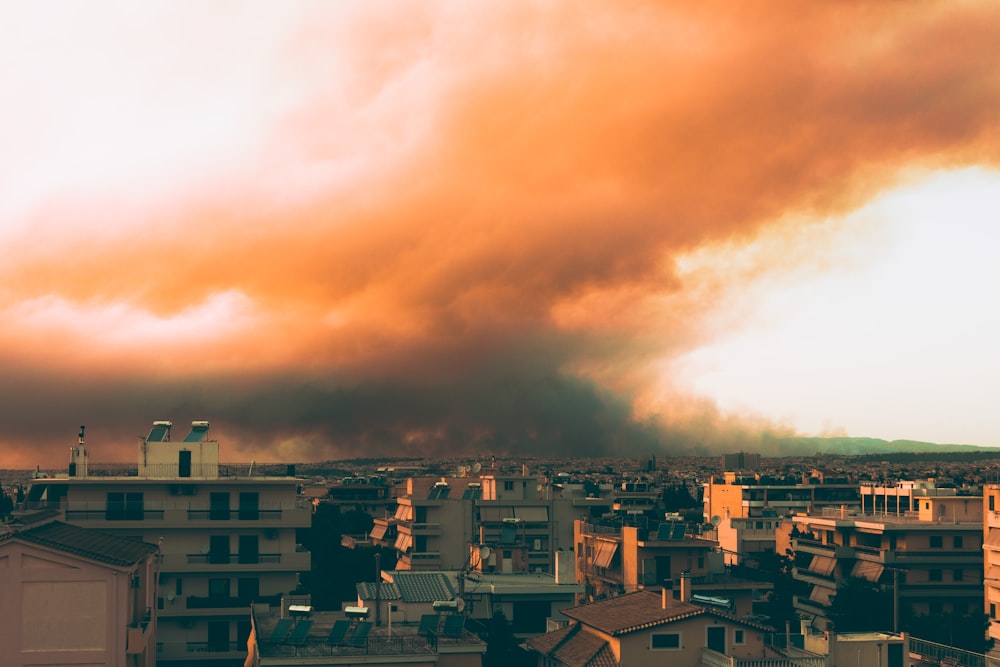 city with high rise buildings under white clouds during daytime