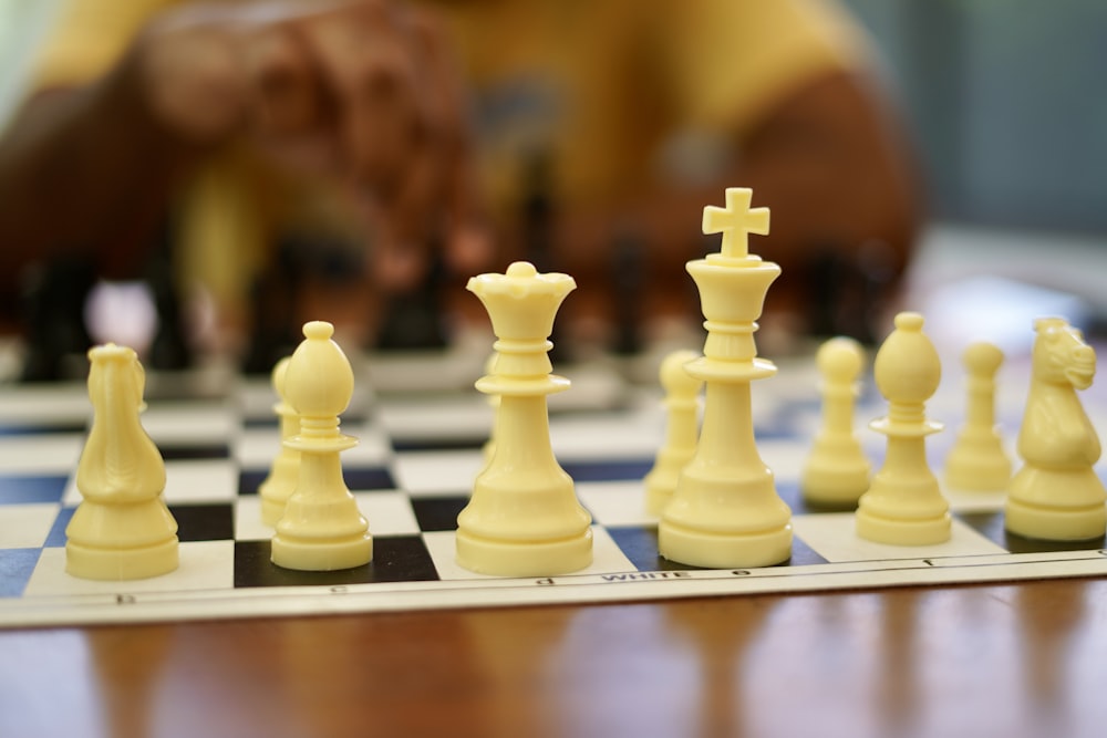 yellow chess piece on brown wooden shelf